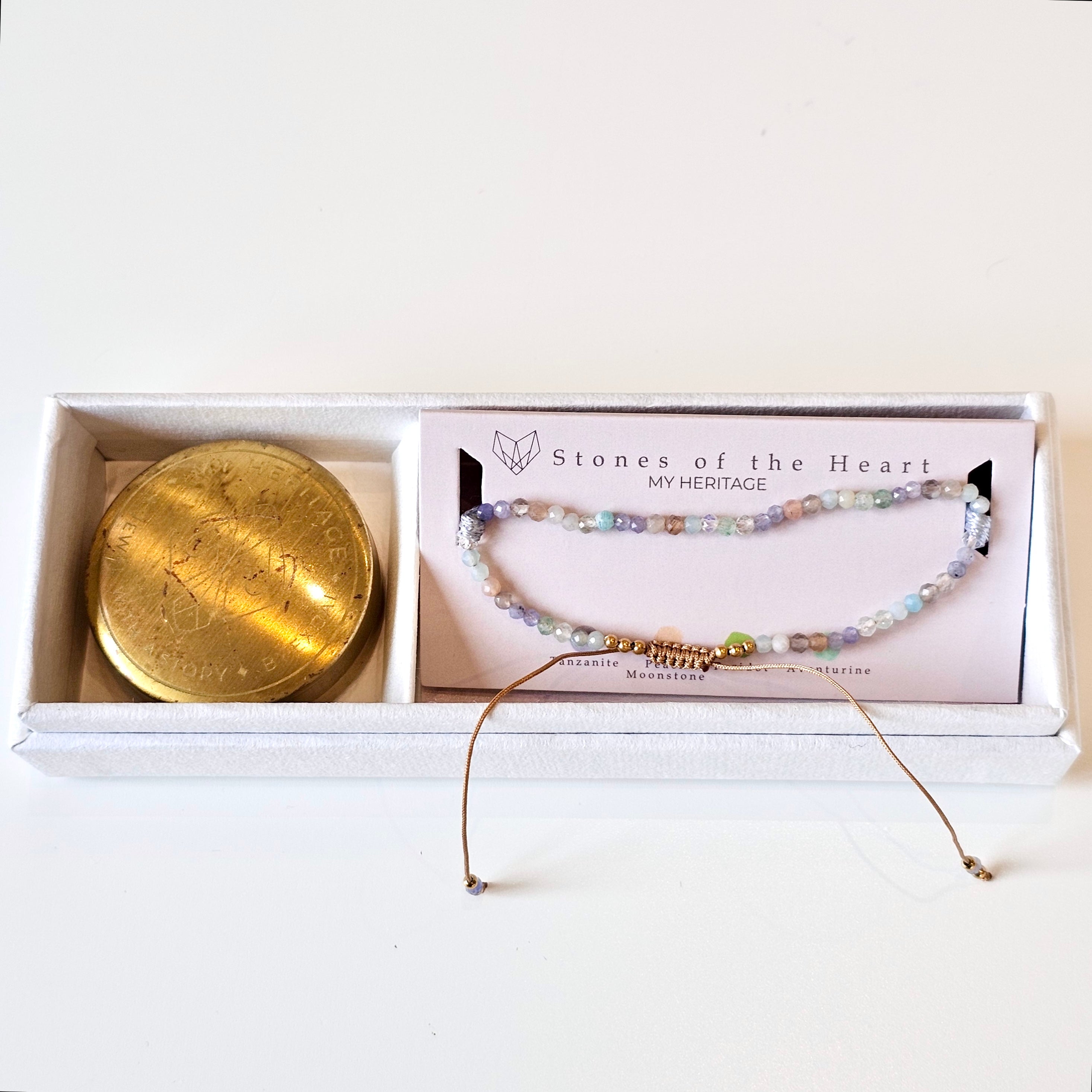 Beaded gemstone and gold bracelet in presentation box with gold travel tin. 