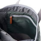 Close-up of a backpack inner zipper pocket with a brown pull tab on a white background