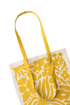 Yellow floral-patterned tote bag on a white background