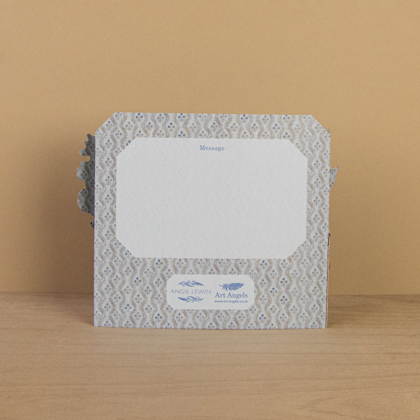 Decorative card with a patterned border  on a wooden surface