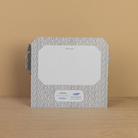 Decorative card with a patterned border  on a wooden surface