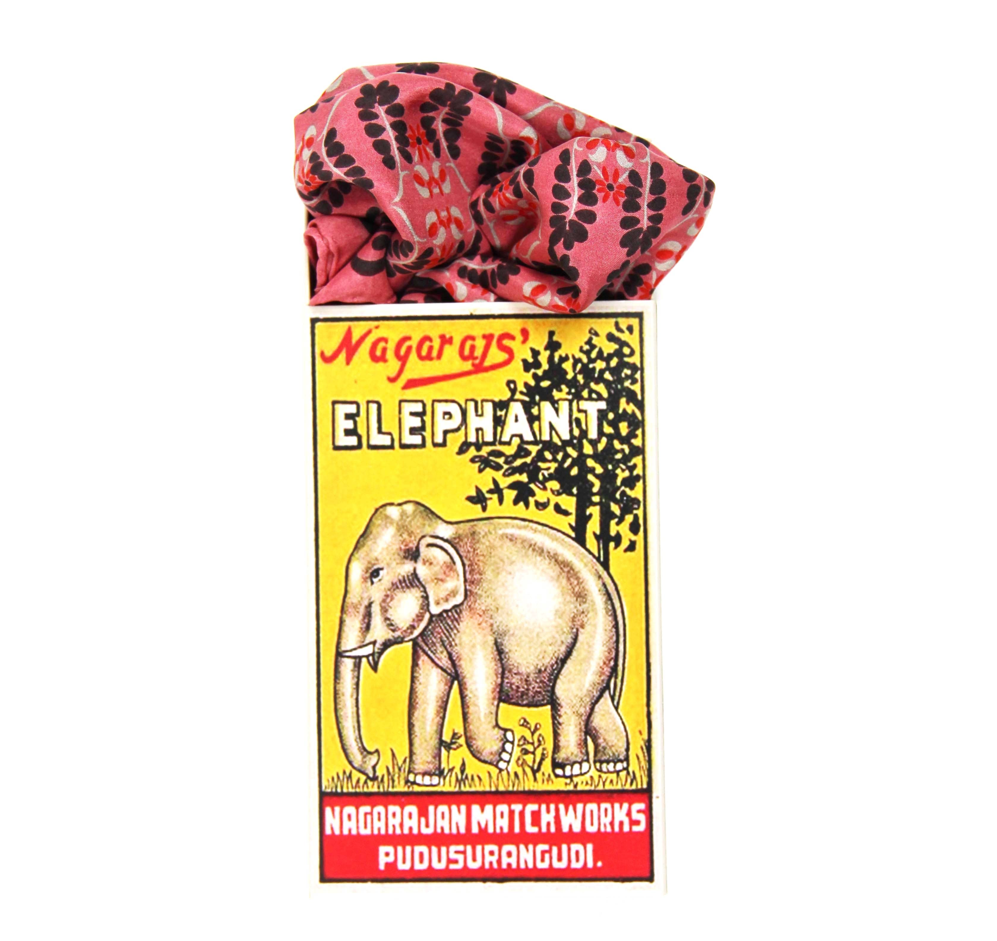 Matchbox with elephant illustration and pink cover on white background
