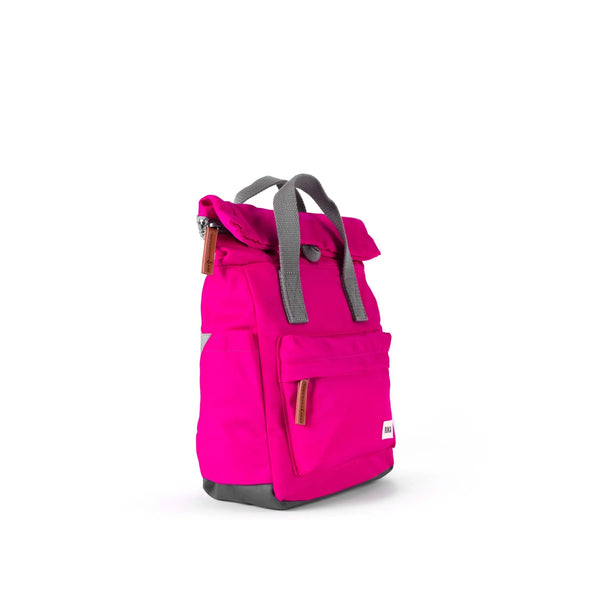 Photo showing the front and side of a small bright pink backpack. There is a large pocket on the front with a brown zip pull, and the handles are grey.