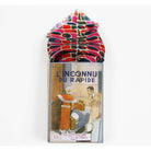 A folded multicolor patterned scarf or handkerchief displayed on top of its vintage illustrated box. The fabric has an abstract organic pattern in pink, red, blue, black, and white, with fringed edges.