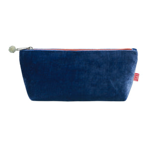 photo of a dark blue velvet pouch with bright orange zip and beaded zip pull, against a white background
