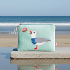 Seagull pouch on a stone ledge with ocean view