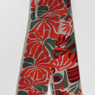 Floral patterned tie with red and green design on a white background