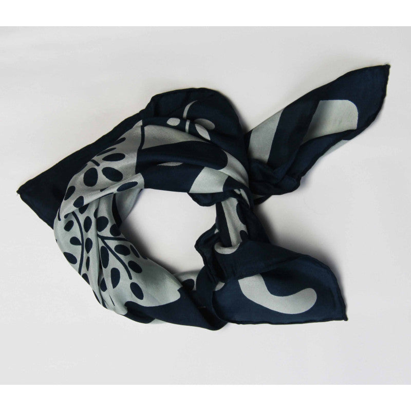 Navy and white patterned scarf on a light gray background