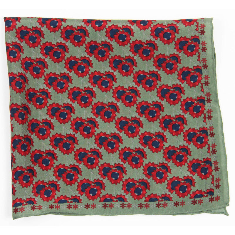 Patterned fabric with red and blue floral design on a green background