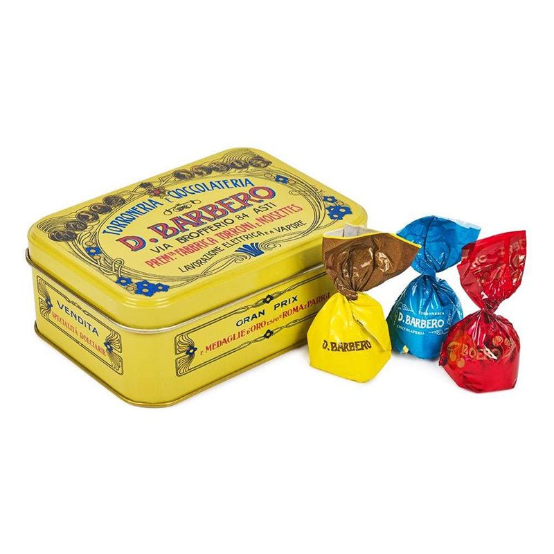 Yellow tin with 'D. Barbero' branding and colorful candy packages on a white background
