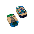 Two blue containers with cardboard lids on a green background