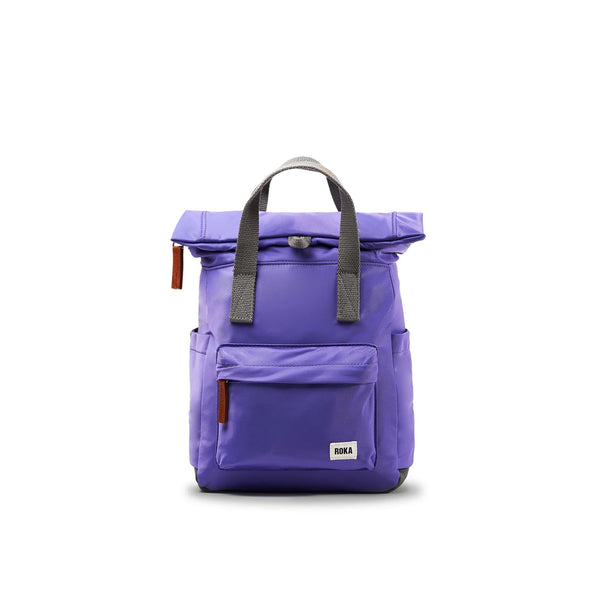 Photo showing the front of a small purple backpack. There is a large pocket on the front with a brown zip pull, and the handles are grey.