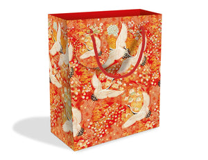 Short rectangular gift bag with pattern made up of white cranes against a red, orange and yellow floral background