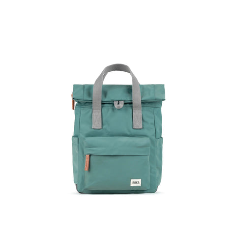photo showing the front of a small sage green coloured backpack. There is a large pocket on the front with a brown zip pull, and the handles are grey.