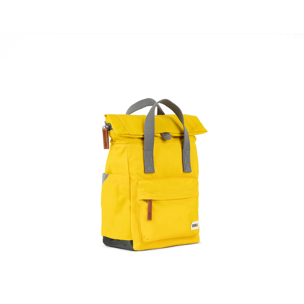 Photo showing the front and side of a small yellow backpack. There is a large pocket on the front with a brown zip pull, and the handles are grey.