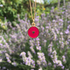 red heart necklace in front of lavender 