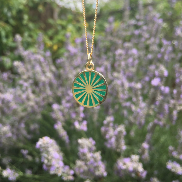 spinning wheel in green with gold vermeil  in front of lavender plants 