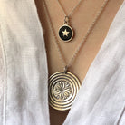black star necklace with a large medallion 