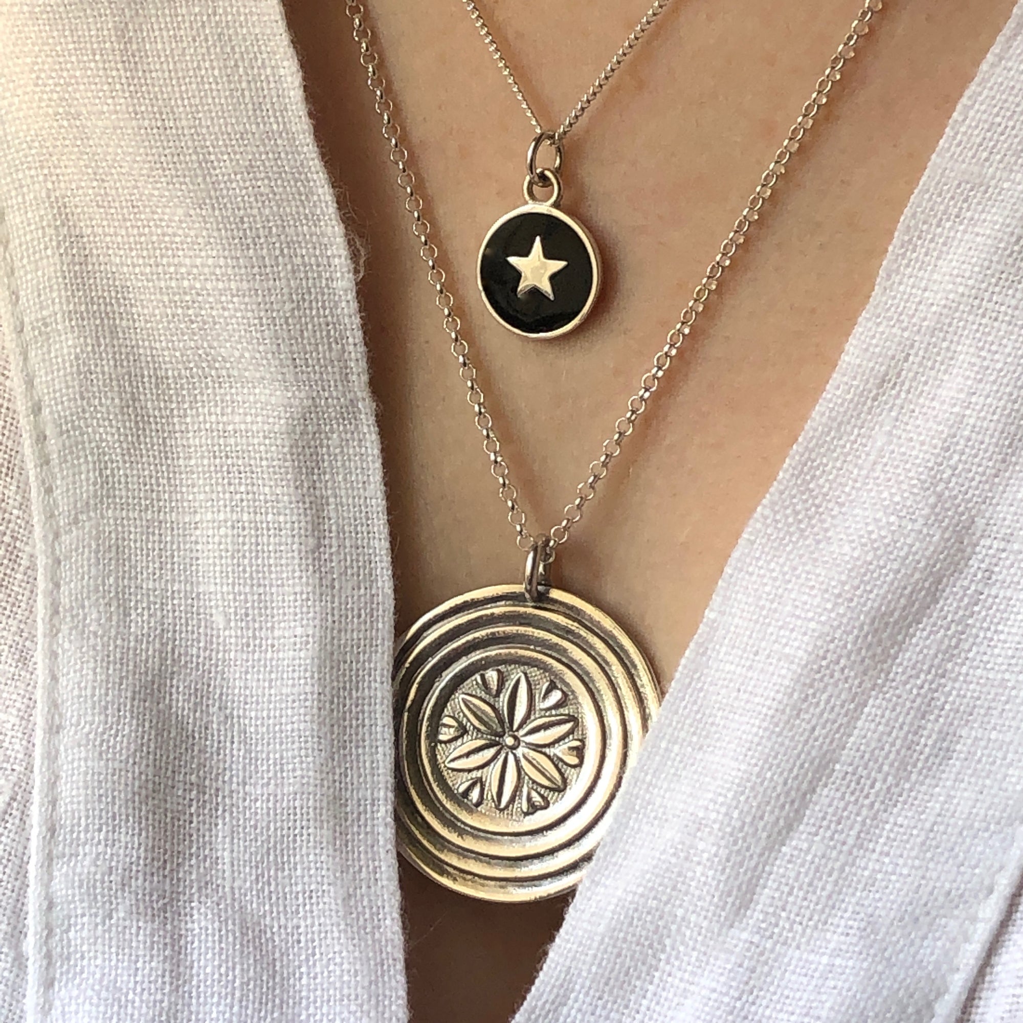 black star necklace with a large medallion 