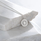 silver daisy on marble slab 