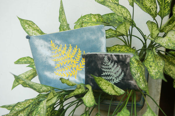 large cosmetic purse to scale with a small velvet purse in fern design 
