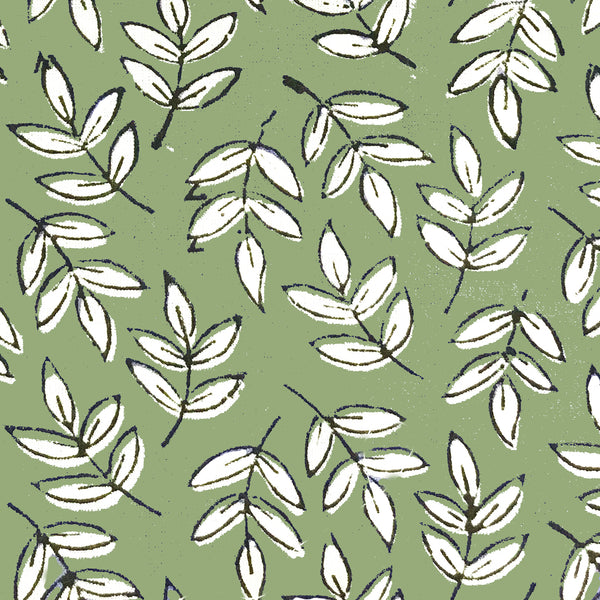 block print fabric close up of green leaf design 