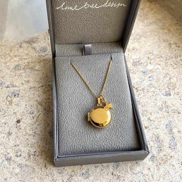 round gold locket with star